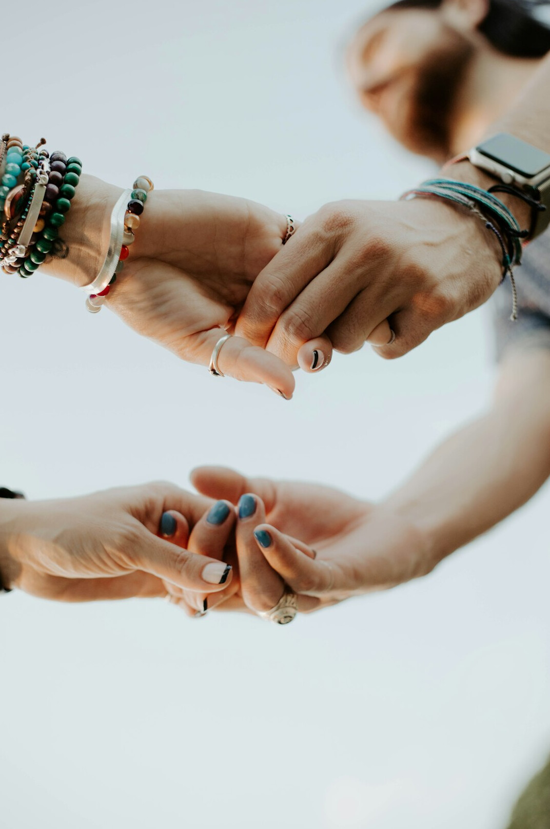 Colleagues joining hands in teamwork
